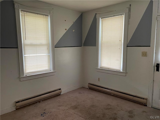 carpeted empty room with a baseboard radiator