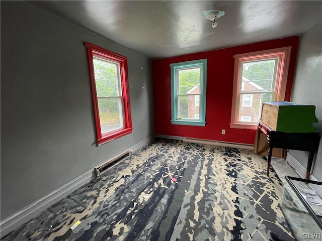 interior space with baseboard heating and plenty of natural light