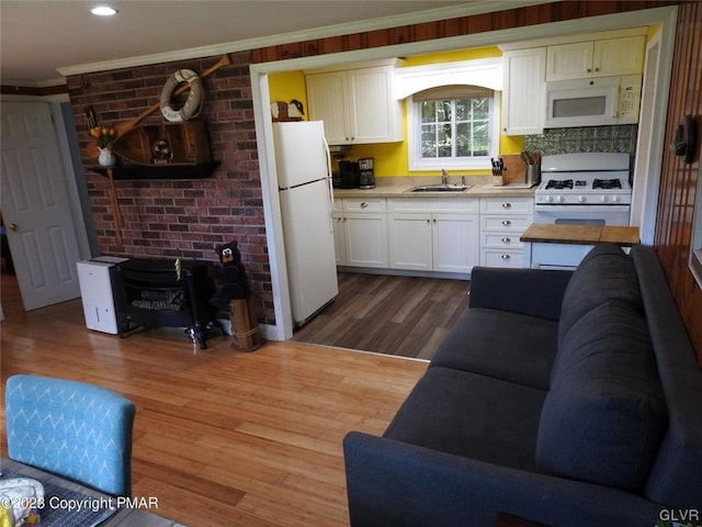 interior space with sink, crown molding, and dark hardwood / wood-style flooring