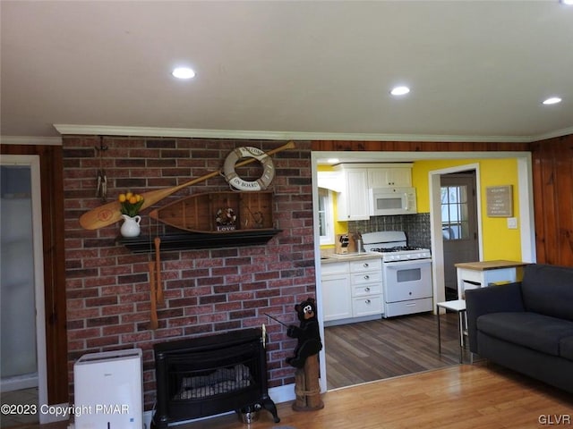 living room featuring a fireplace, crown molding, and dark hardwood / wood-style flooring