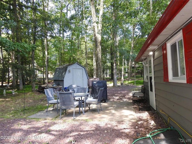 view of patio / terrace with a storage shed and area for grilling