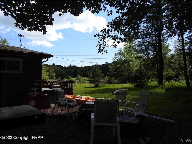 view of yard with an outdoor fire pit