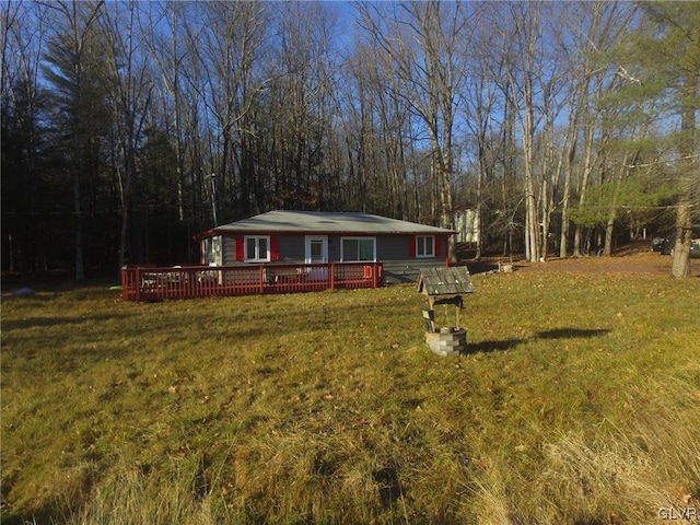 view of front facade with a deck and a front yard