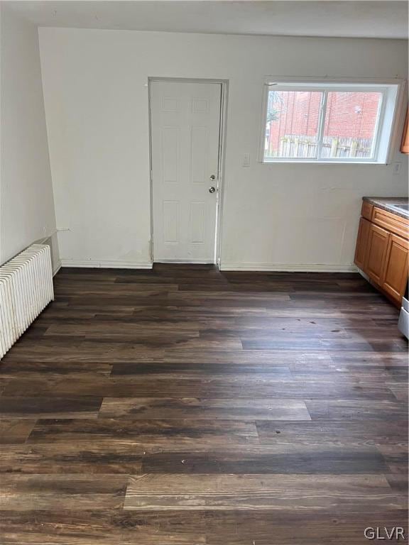 empty room with dark hardwood / wood-style flooring