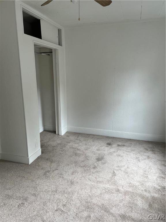 unfurnished bedroom with light carpet and ceiling fan