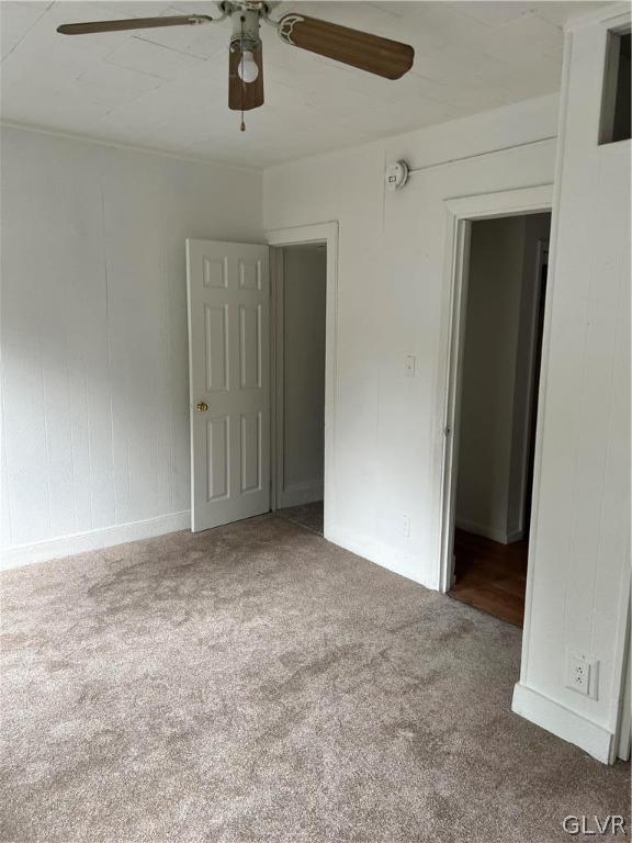 unfurnished bedroom with carpet and ceiling fan