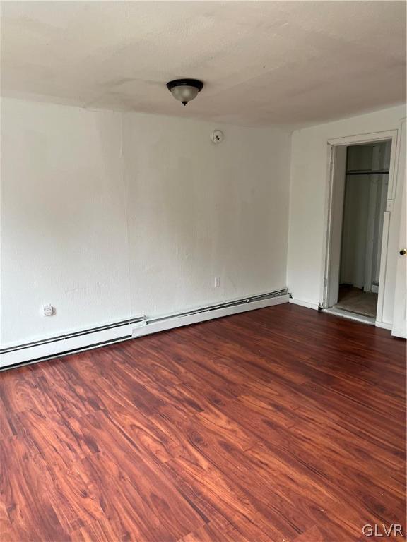 spare room with wood-type flooring