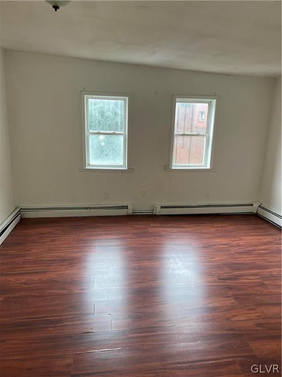 spare room featuring hardwood / wood-style flooring and plenty of natural light