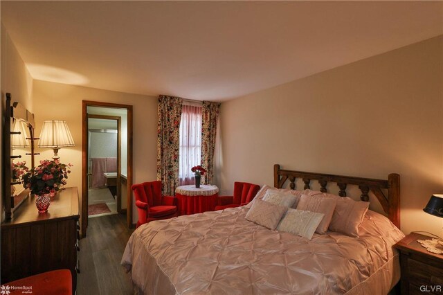 bedroom featuring dark hardwood / wood-style flooring and ensuite bathroom