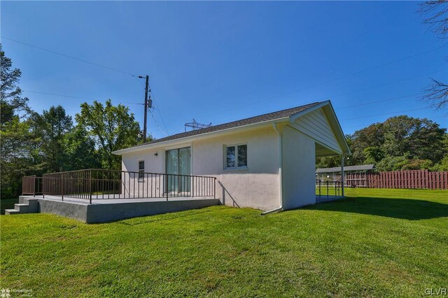 rear view of property with a lawn