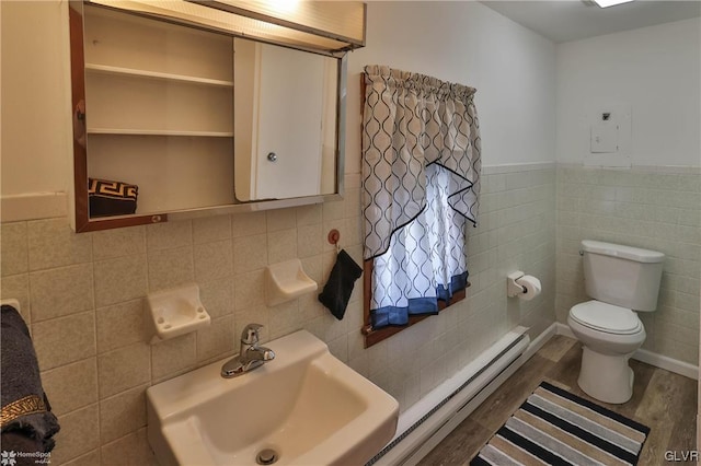 bathroom with tile walls, sink, and wood-type flooring