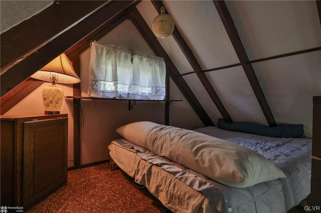 bedroom with carpet floors and lofted ceiling