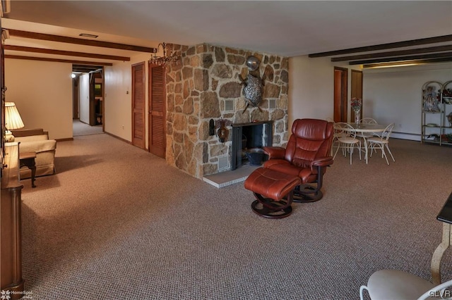 living room featuring beam ceiling, carpet, and a fireplace