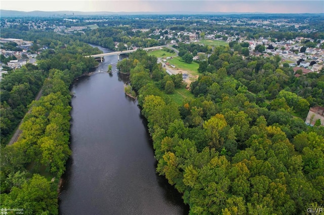 drone / aerial view of a nearby body of water and a notable bridge