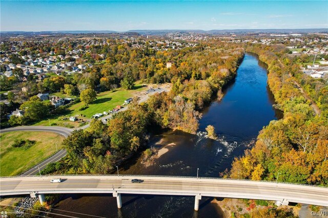 aerial view of property and surrounding area featuring a nearby body of water