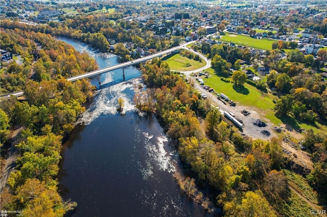 aerial view of property and surrounding area with a nearby body of water and a notable bridge