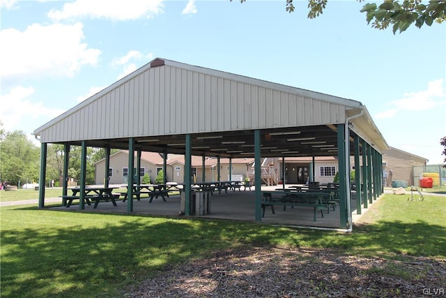 surrounding community with a lawn and a patio