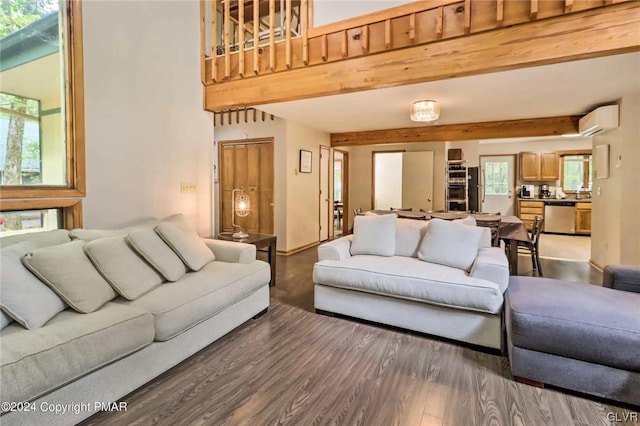 living room with dark hardwood / wood-style flooring, beamed ceiling, and a wall mounted air conditioner