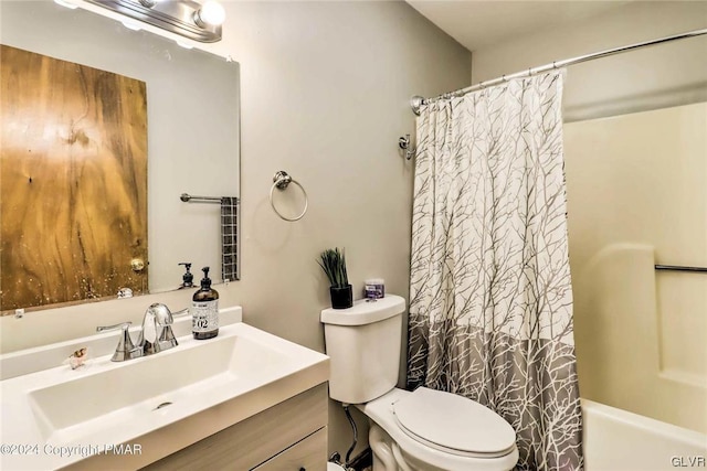 full bathroom featuring shower / bath combo, vanity, and toilet