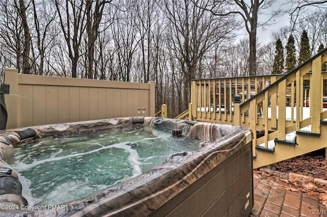 wooden deck featuring a hot tub