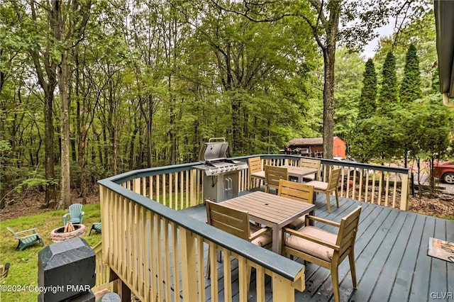 wooden terrace with an outdoor fire pit