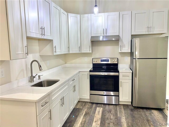 kitchen featuring appliances with stainless steel finishes, dark hardwood / wood-style floors, and white cabinetry