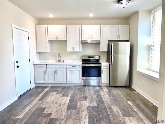 kitchen with stainless steel appliances, white cabinets, dark wood-type flooring, and sink