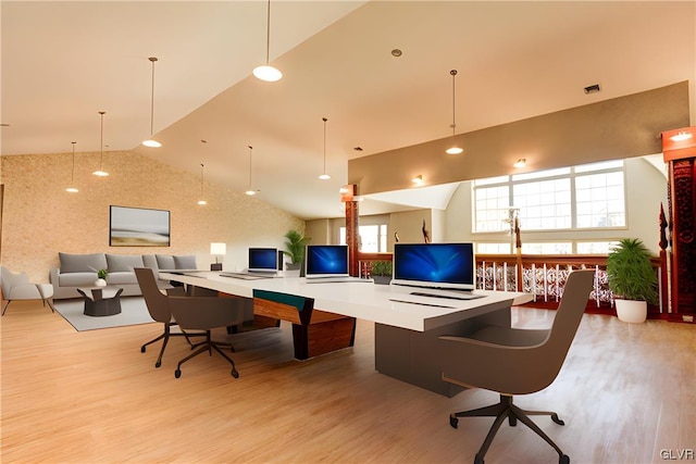 home office featuring vaulted ceiling and light hardwood / wood-style floors