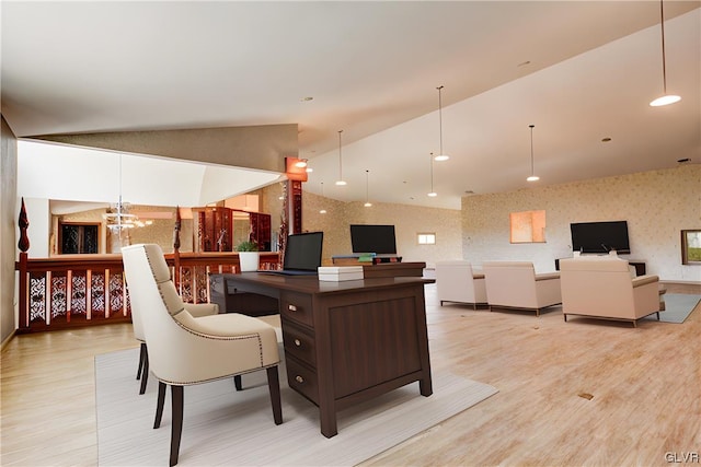 office space with light hardwood / wood-style flooring, lofted ceiling, and an inviting chandelier