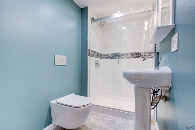 bathroom featuring tile patterned flooring, toilet, and tiled shower