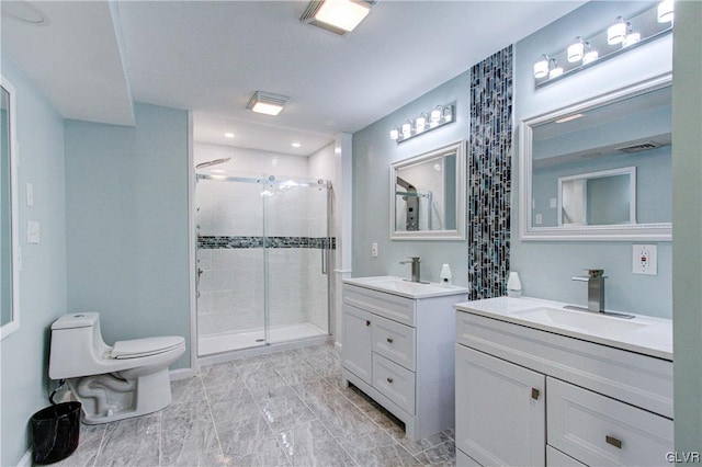 bathroom featuring double sink vanity, toilet, tile patterned flooring, and a shower with shower door