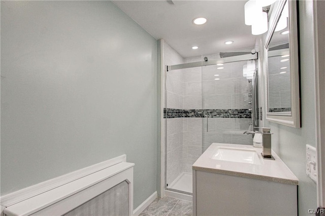 bathroom featuring a shower with door, vanity, and tile patterned flooring