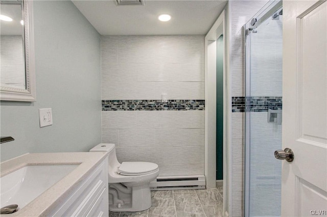 bathroom featuring a baseboard radiator, tile walls, toilet, vanity, and tile patterned flooring