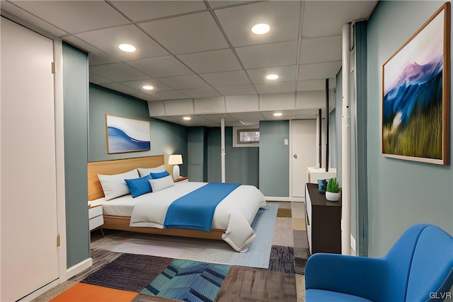 bedroom featuring a paneled ceiling and wood-type flooring