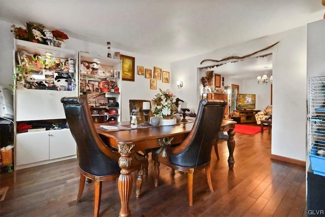 dining room with an inviting chandelier and dark hardwood / wood-style floors