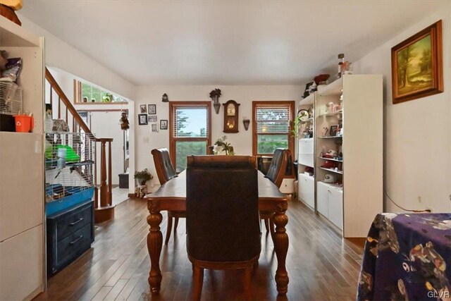 dining space with dark hardwood / wood-style flooring