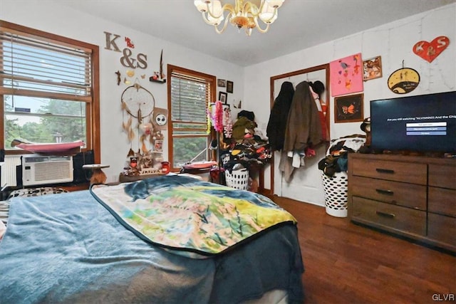 bedroom featuring an inviting chandelier and dark wood-type flooring