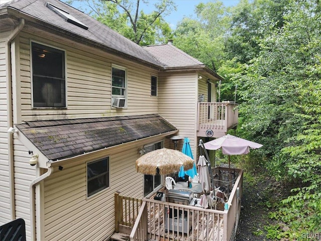 rear view of house with a wooden deck