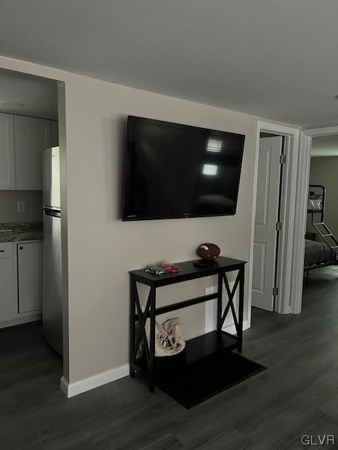 interior space with hardwood / wood-style floors and stainless steel refrigerator