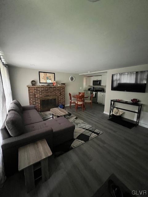 living room featuring hardwood / wood-style flooring and a brick fireplace