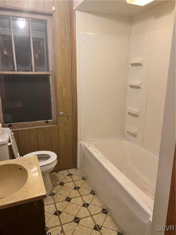 full bathroom with vanity, toilet,  shower combination, and tile patterned floors