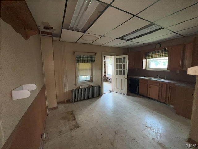 kitchen with dishwasher, a drop ceiling, sink, and radiator heating unit