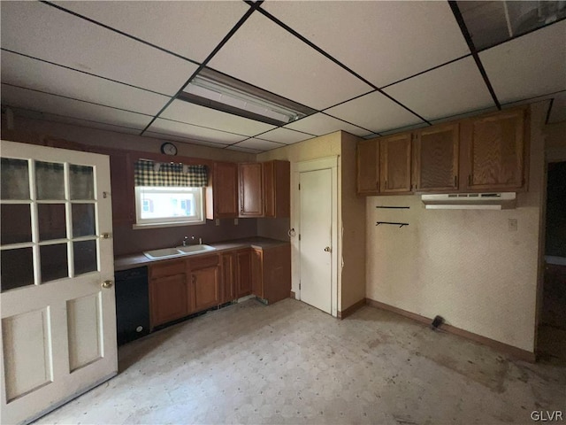 kitchen featuring black dishwasher, sink, and a drop ceiling