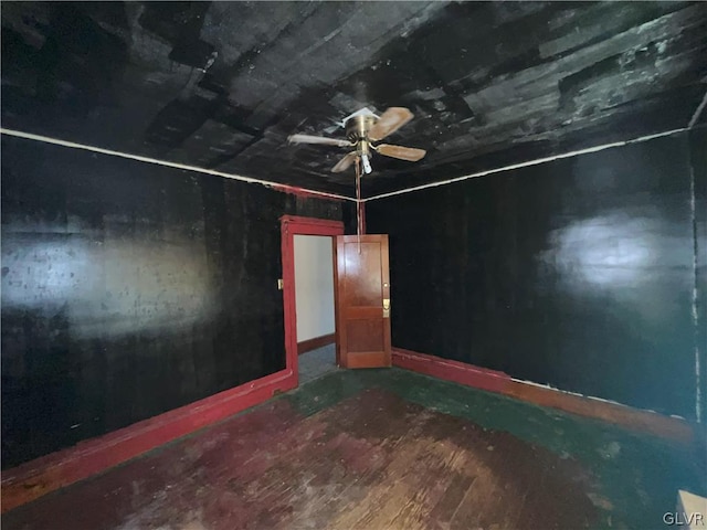 empty room with ceiling fan and wood-type flooring