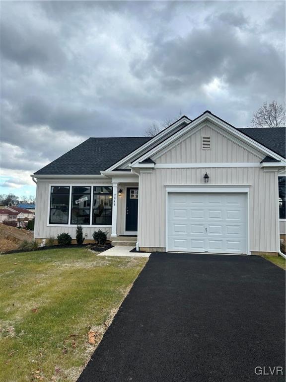 single story home featuring a front yard and a garage