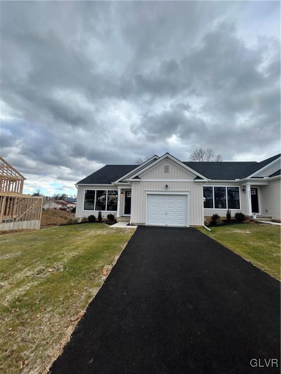 2848 Norton Ave Unit 4, Palmer Twp, PA 18045 - view of front of property featuring an attached garage, asphalt driveway, a front yard, and board and batten siding