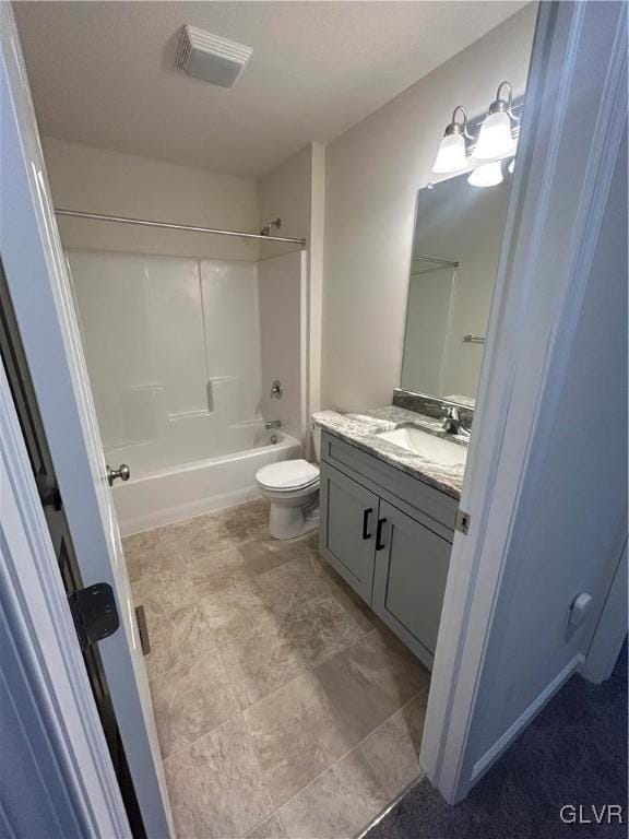 full bathroom featuring washtub / shower combination, vanity, and toilet