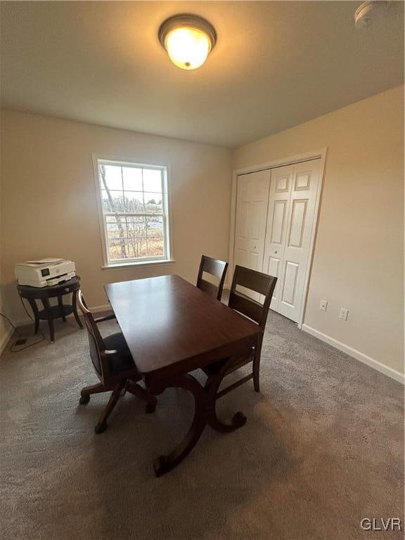 dining area with dark colored carpet