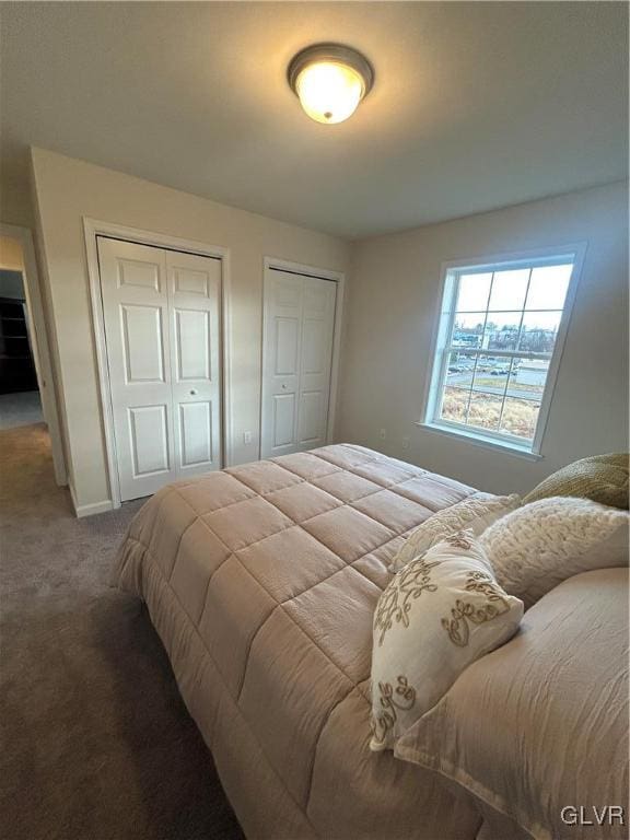 carpeted bedroom featuring two closets