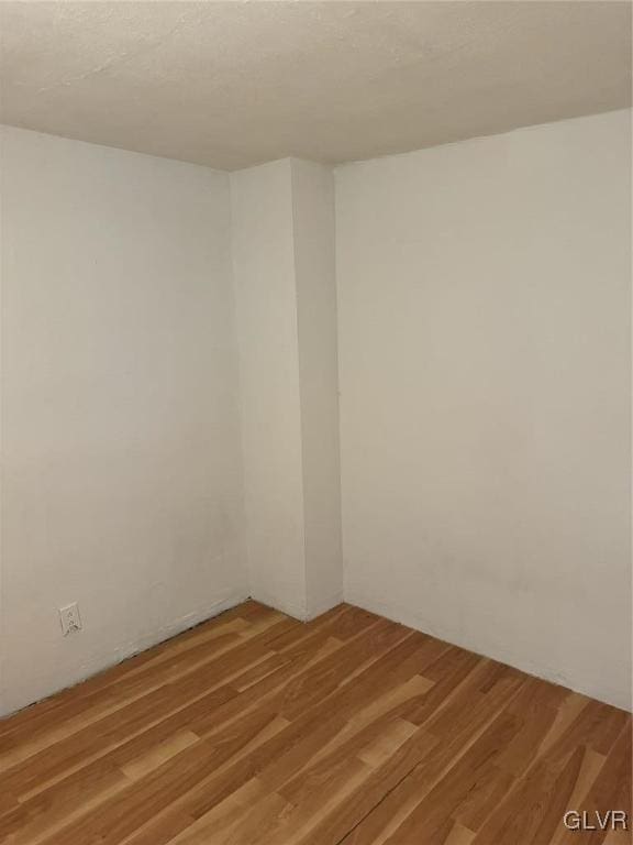 empty room featuring hardwood / wood-style flooring